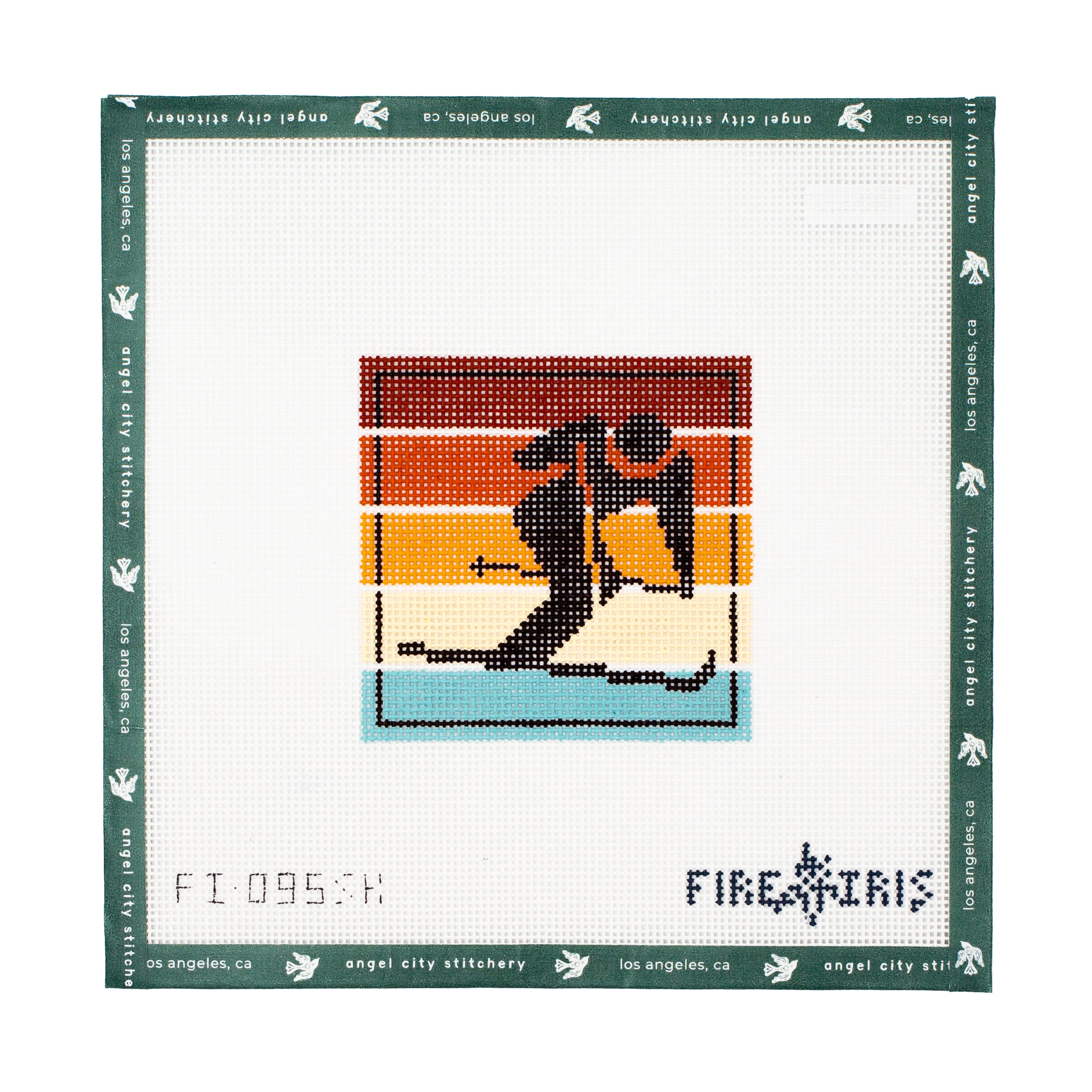 Needlepoint canvas kit with a design of skier, framed by 'Angel City Stitchery' branding.