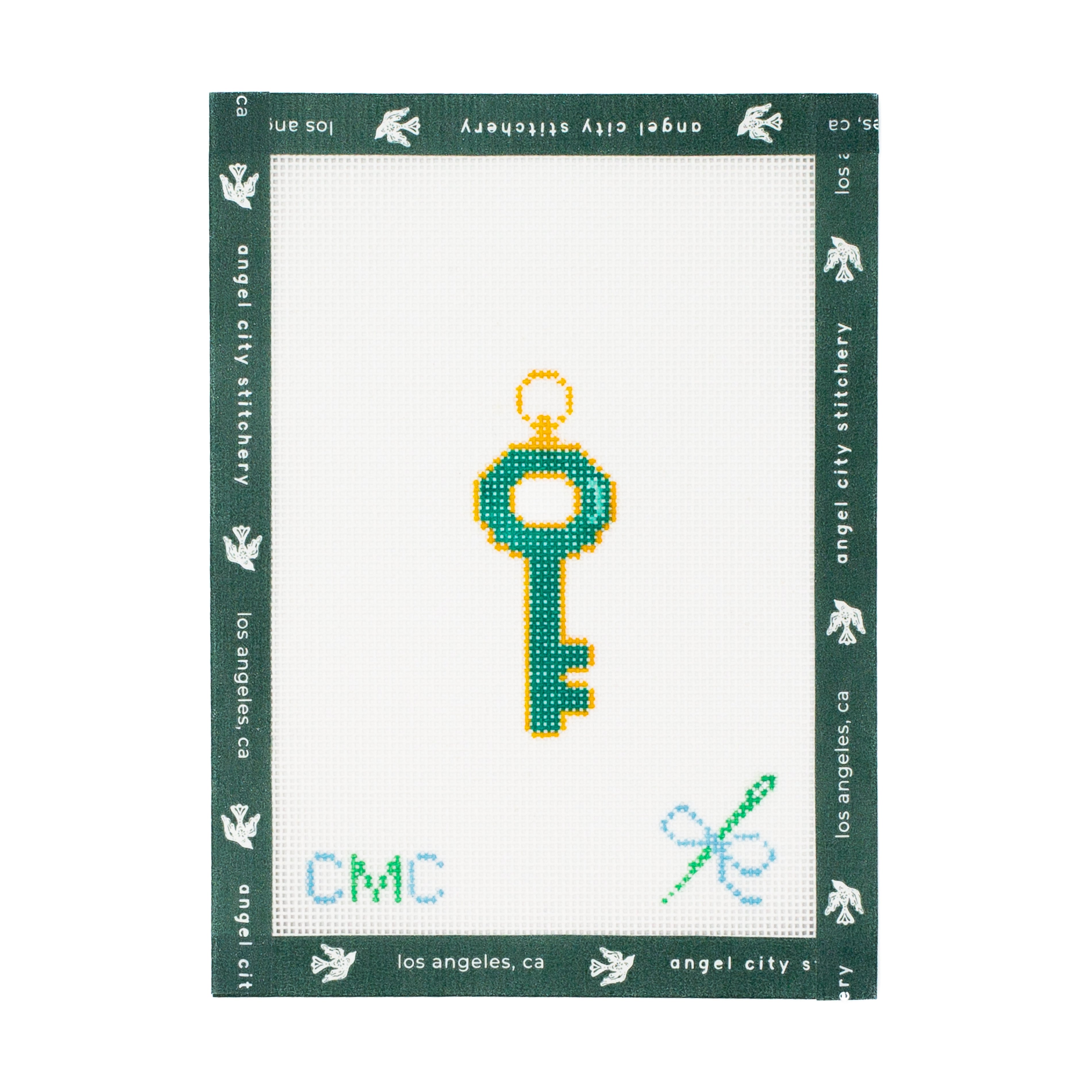 Embroidery canvas key design on a white fabric with green border, featuring 'Angel City Stitchery' branding.