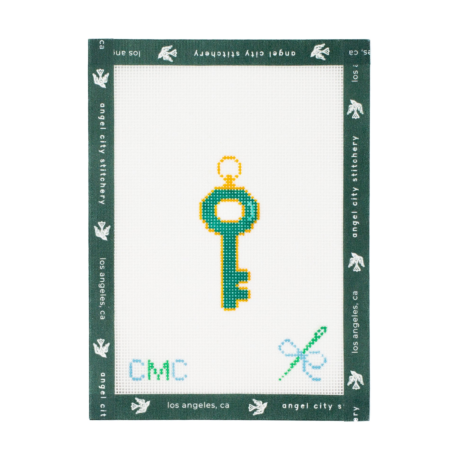 Embroidery canvas key design on a white fabric with green border, featuring 'Angel City Stitchery' branding.