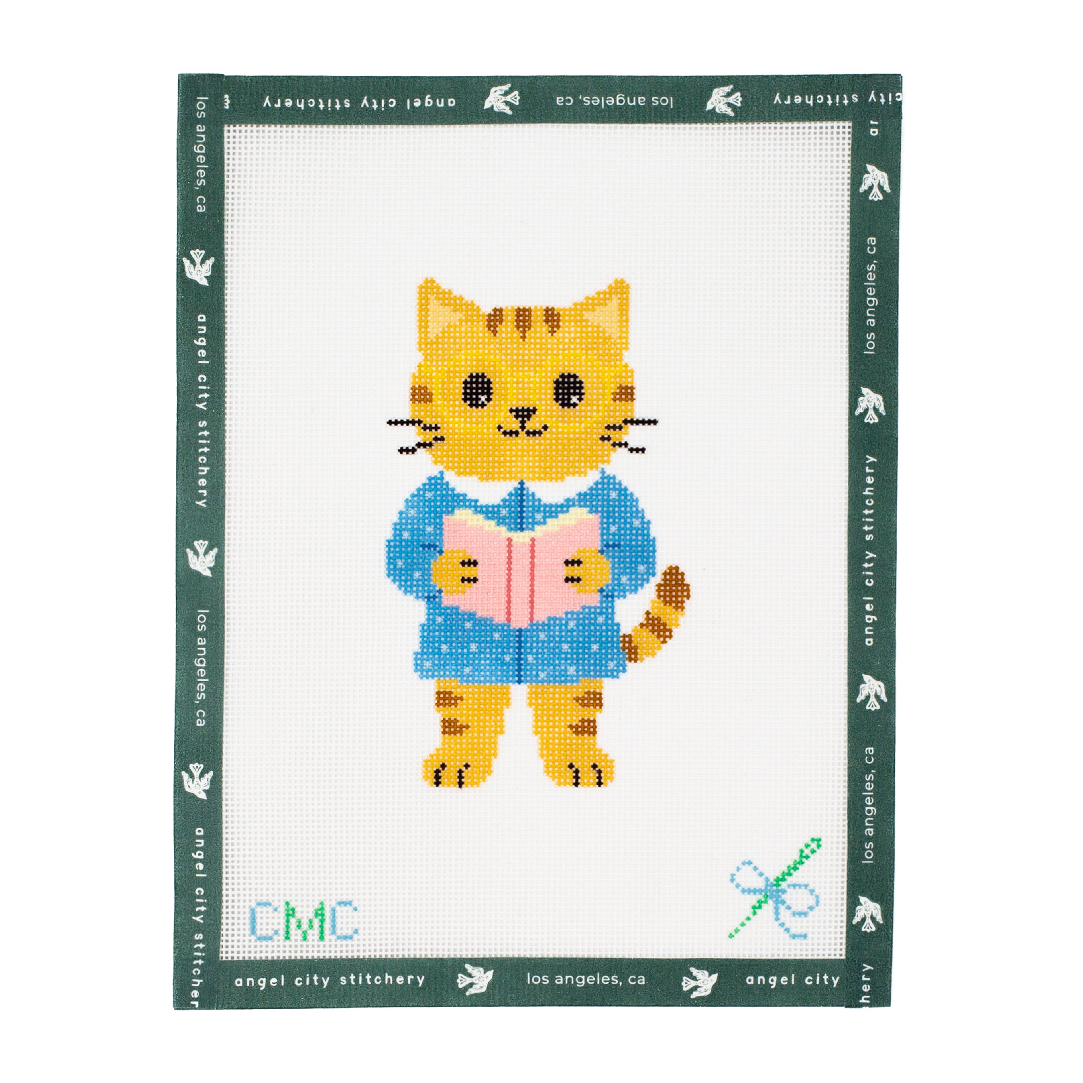 Embroidery canvas pattern of a cat reading a book with 'Angel City Stitchery' branding.