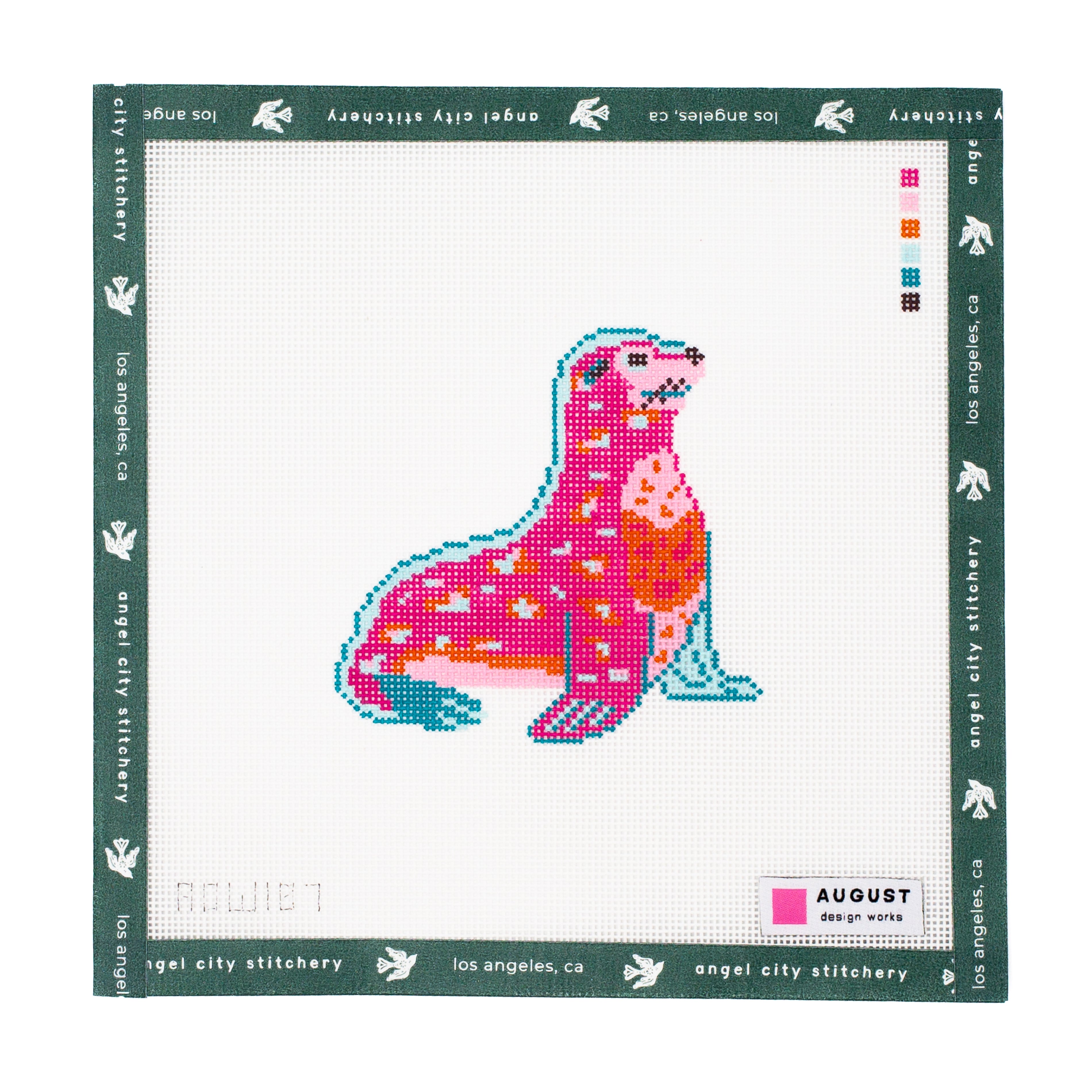 Embroidery canvas pattern with a pink and blue seal design on a white background