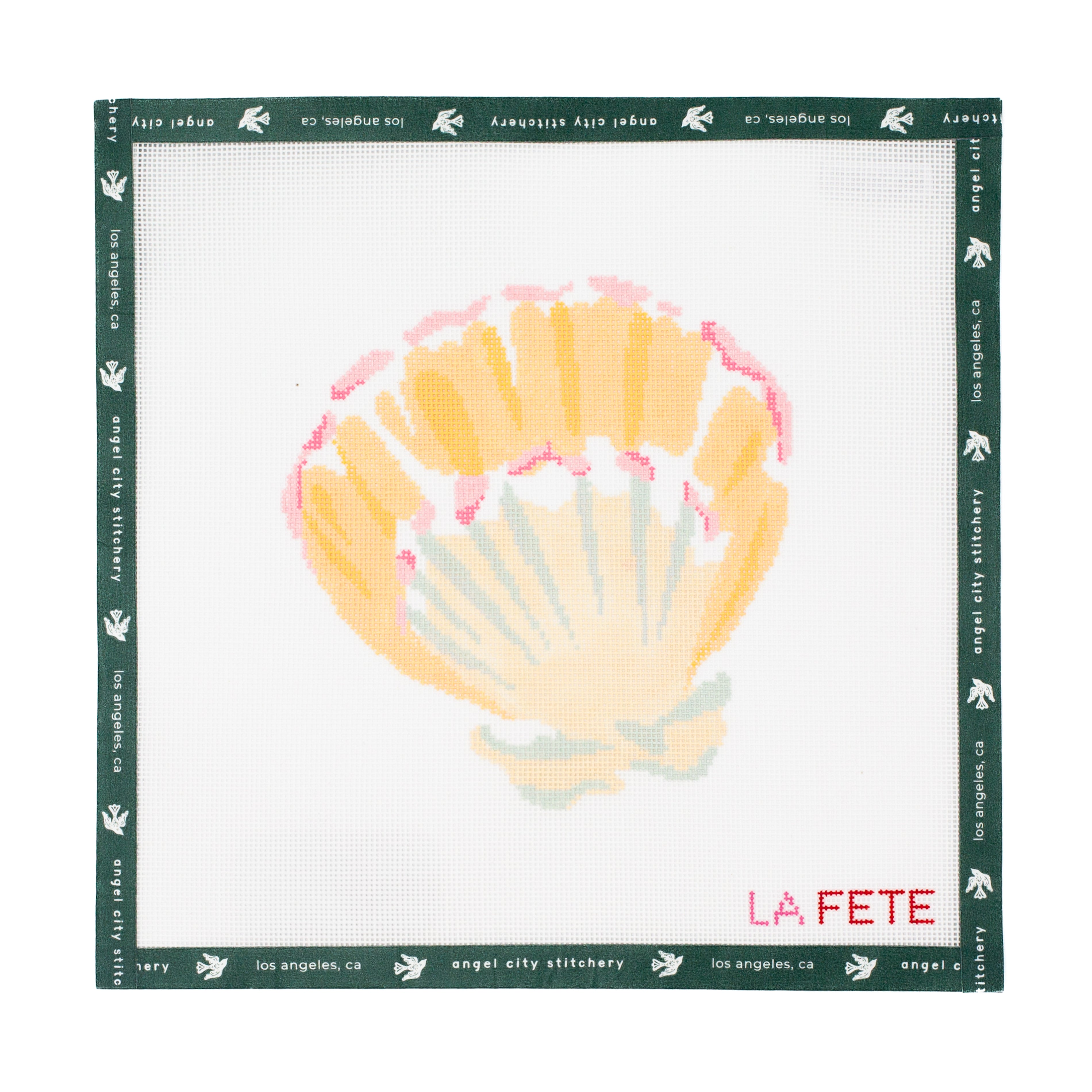 Needlepoint canvas with a shell design and 'La Fete' branding on a white background.