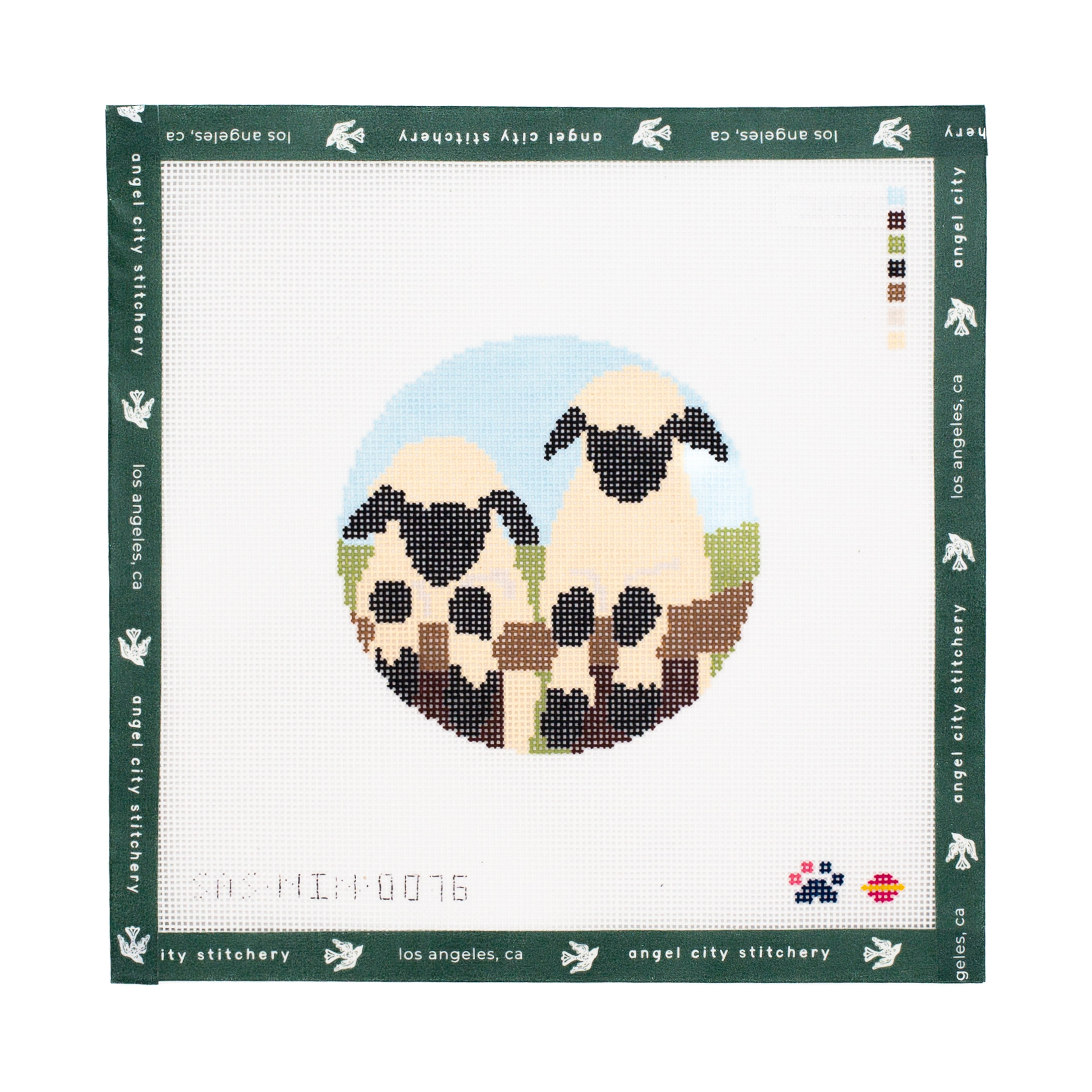 Needlepoint canvas of two sheep in a circle on a white background with 'Angel City Stitchery' branding.