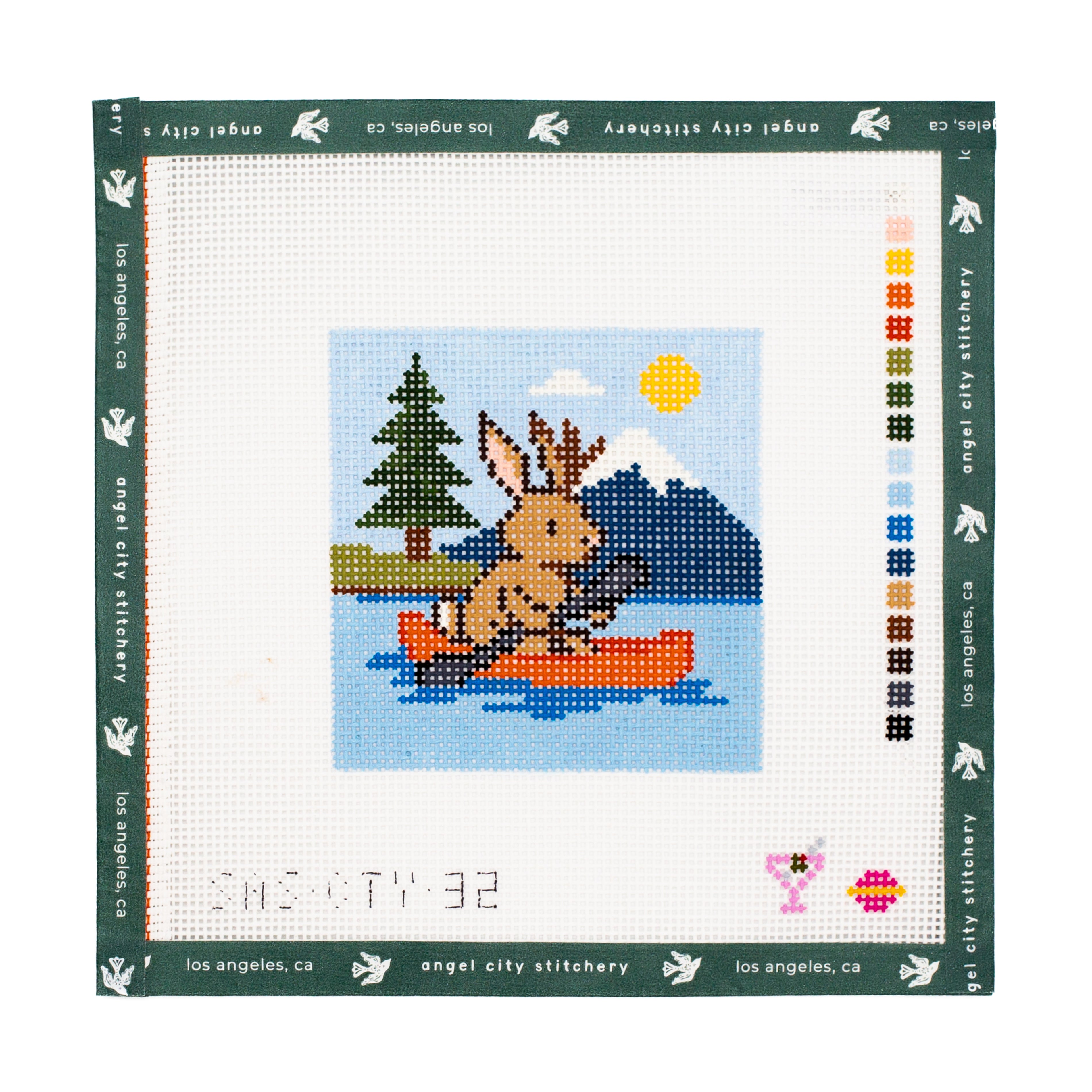 Needlepoint canvas  of a deer in a boat design on a white  background.