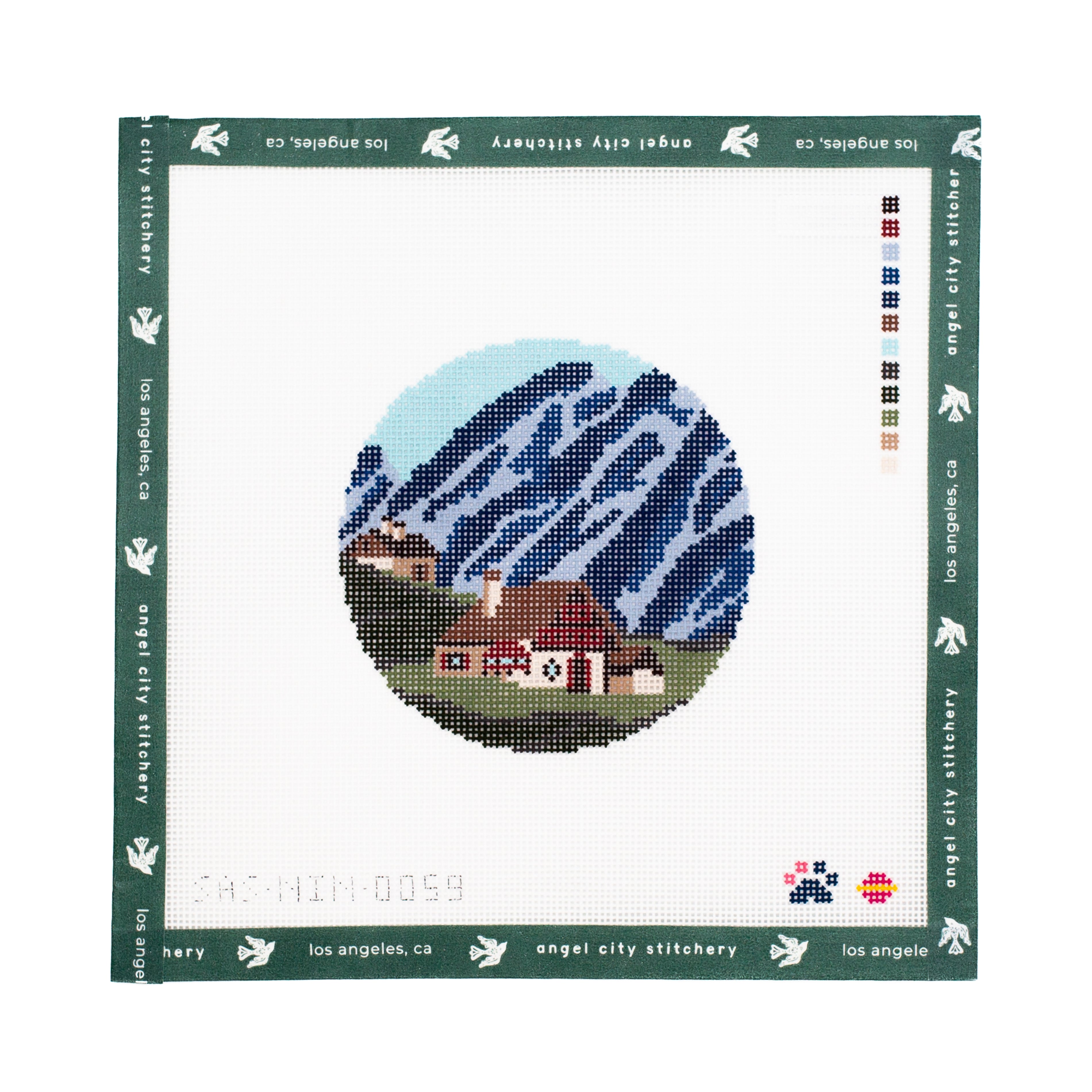 Needlepoint canvas with a scenic design on a white background