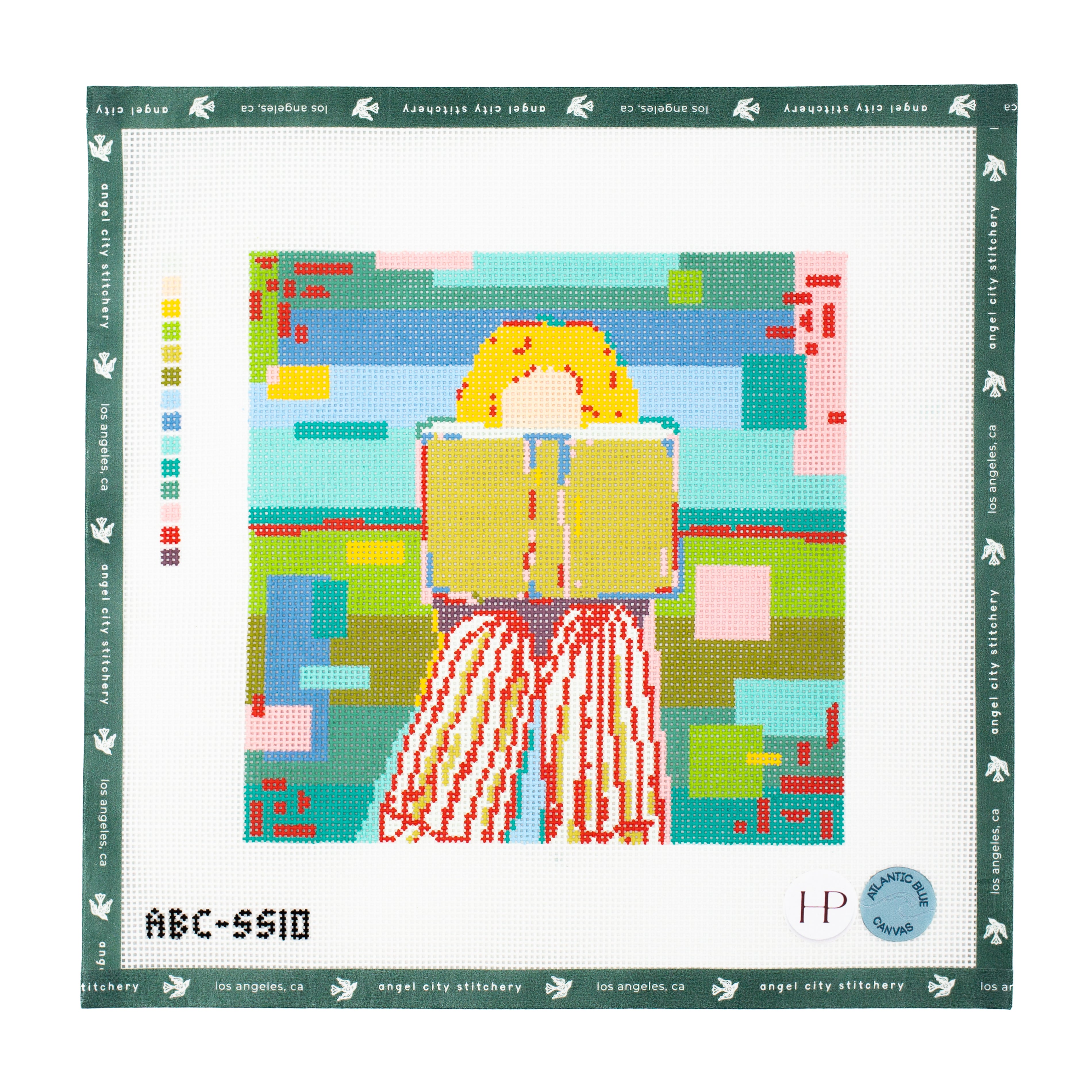 Needlepoint canvas of a person with long hair holding a book, framed by colorful geometric shapes.