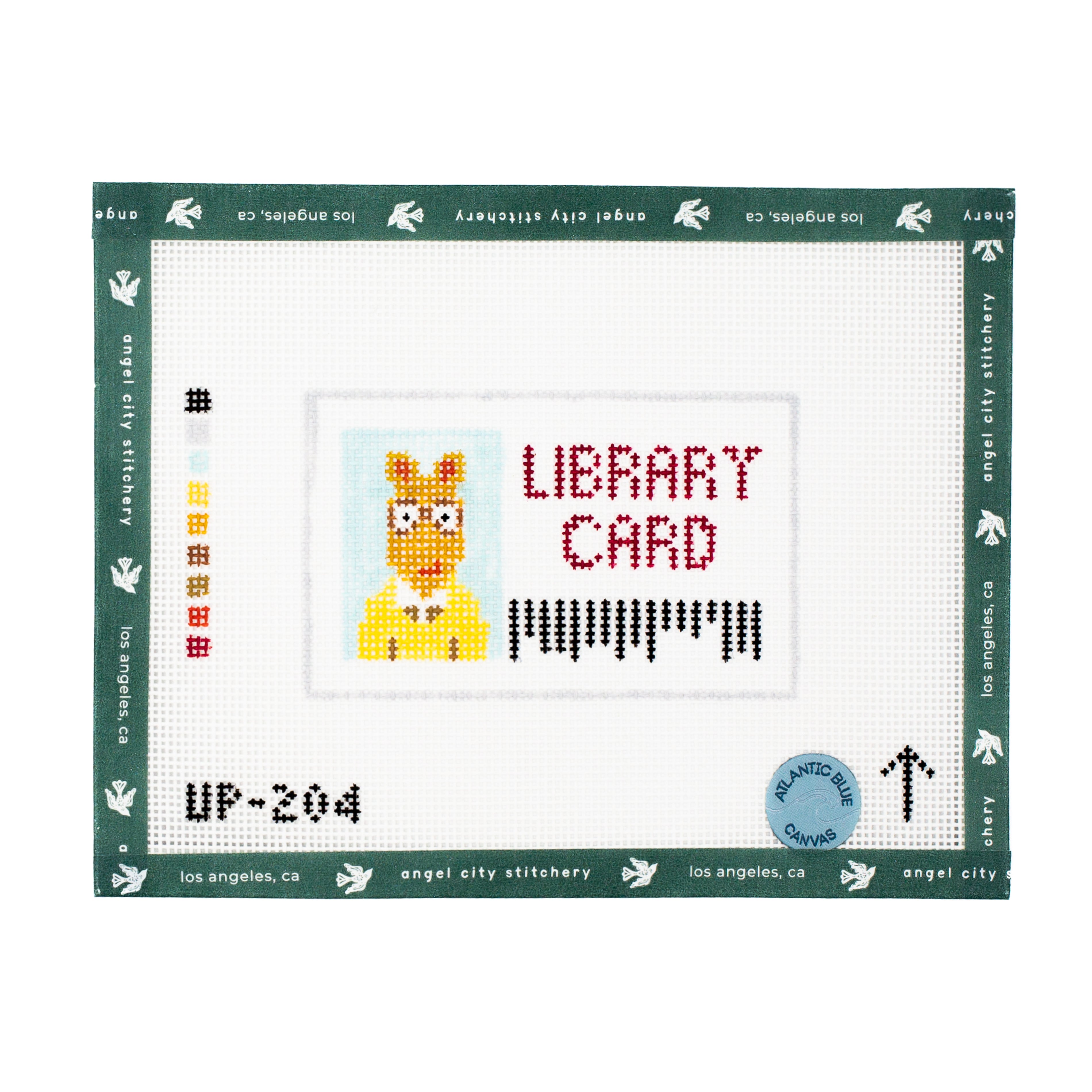 Needlepoint design of a character with text 'LIBRARY CARD' on a white background with green border.