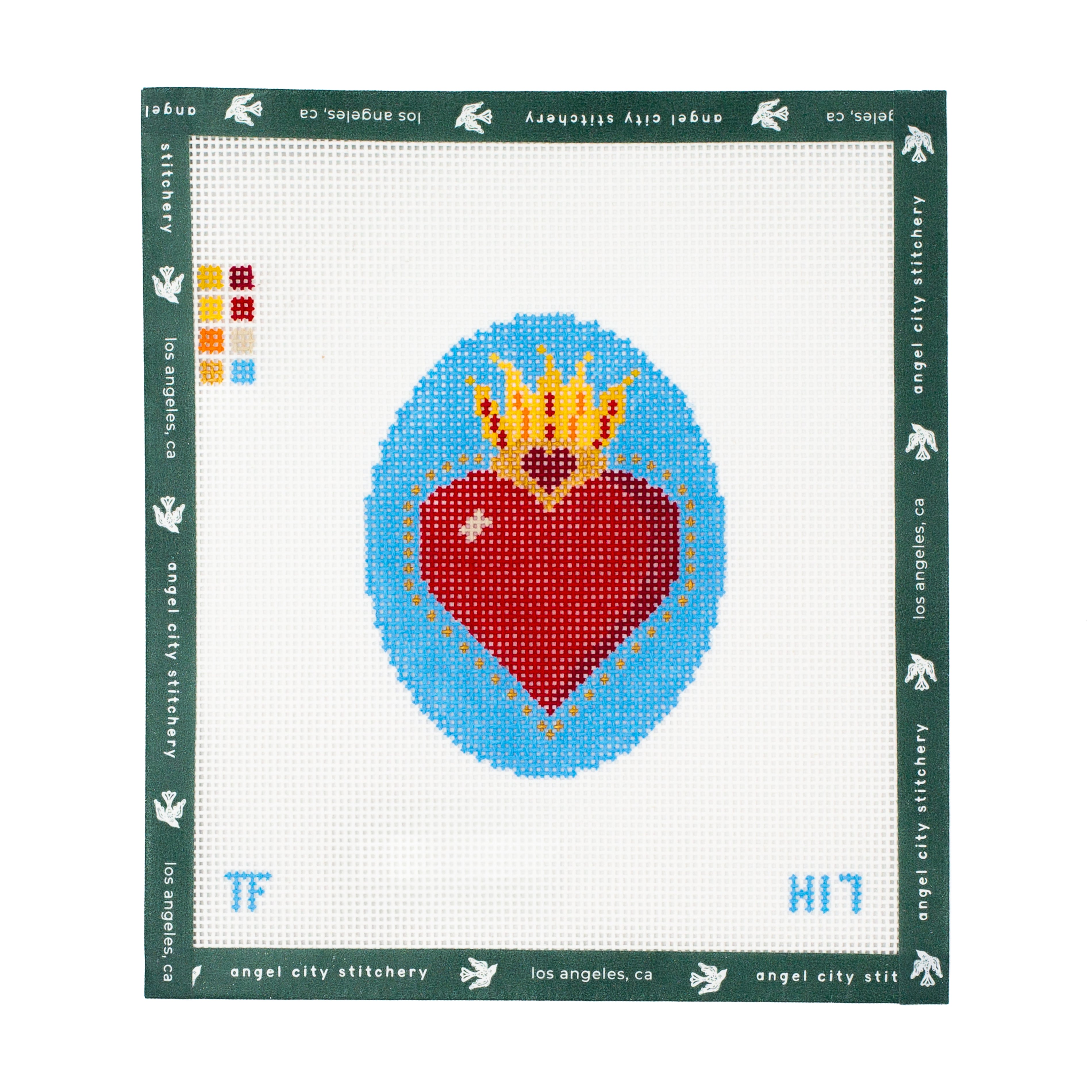 Needlepoint canvas pattern with a red heart and yellow crown on a blue background, framed by Angel City Stitchery branding.