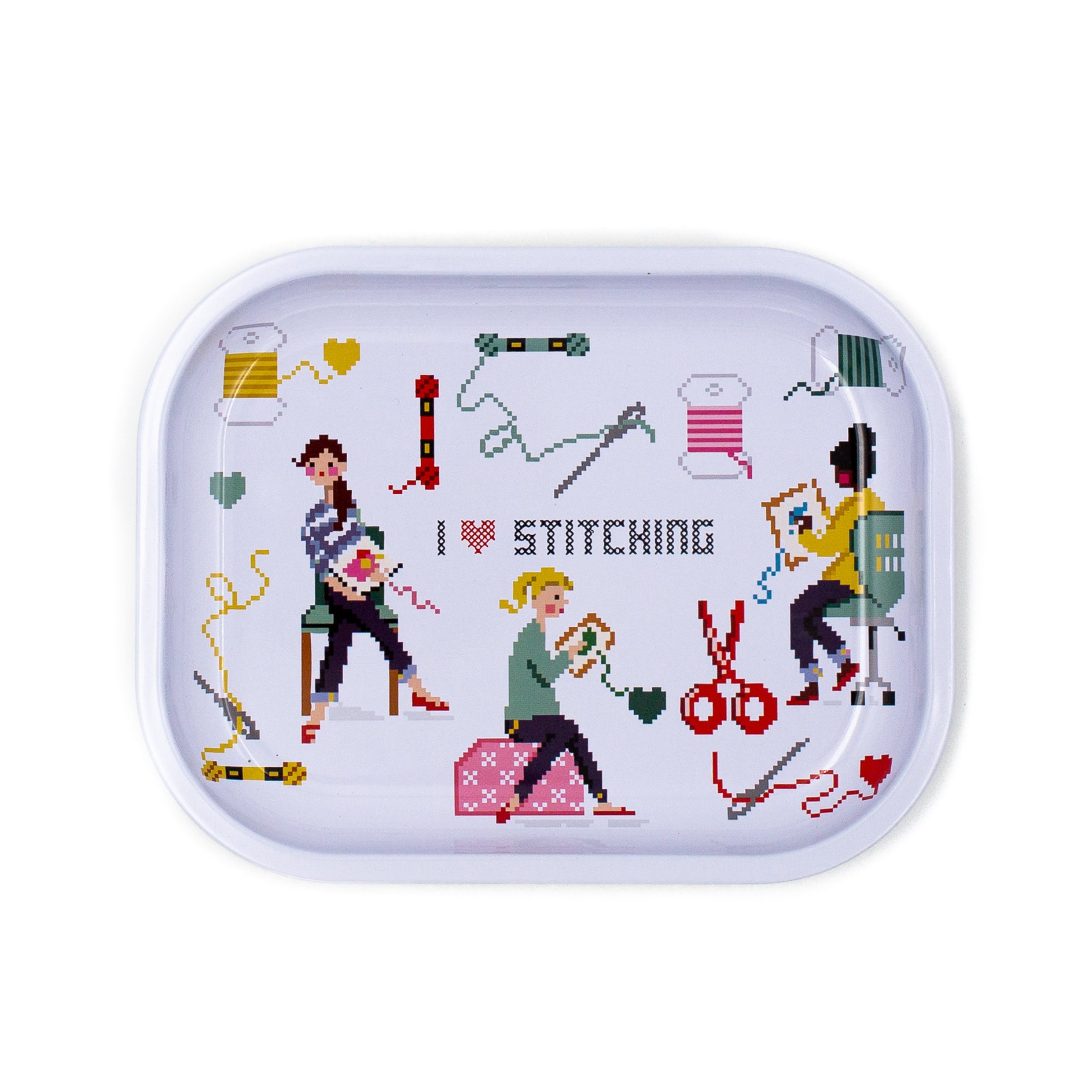 A rectangular metal tin with rounded corners, featuring a colorful cross-stitch style illustration of people sewing and the text 'I ♥ STITCHING' on a white background.