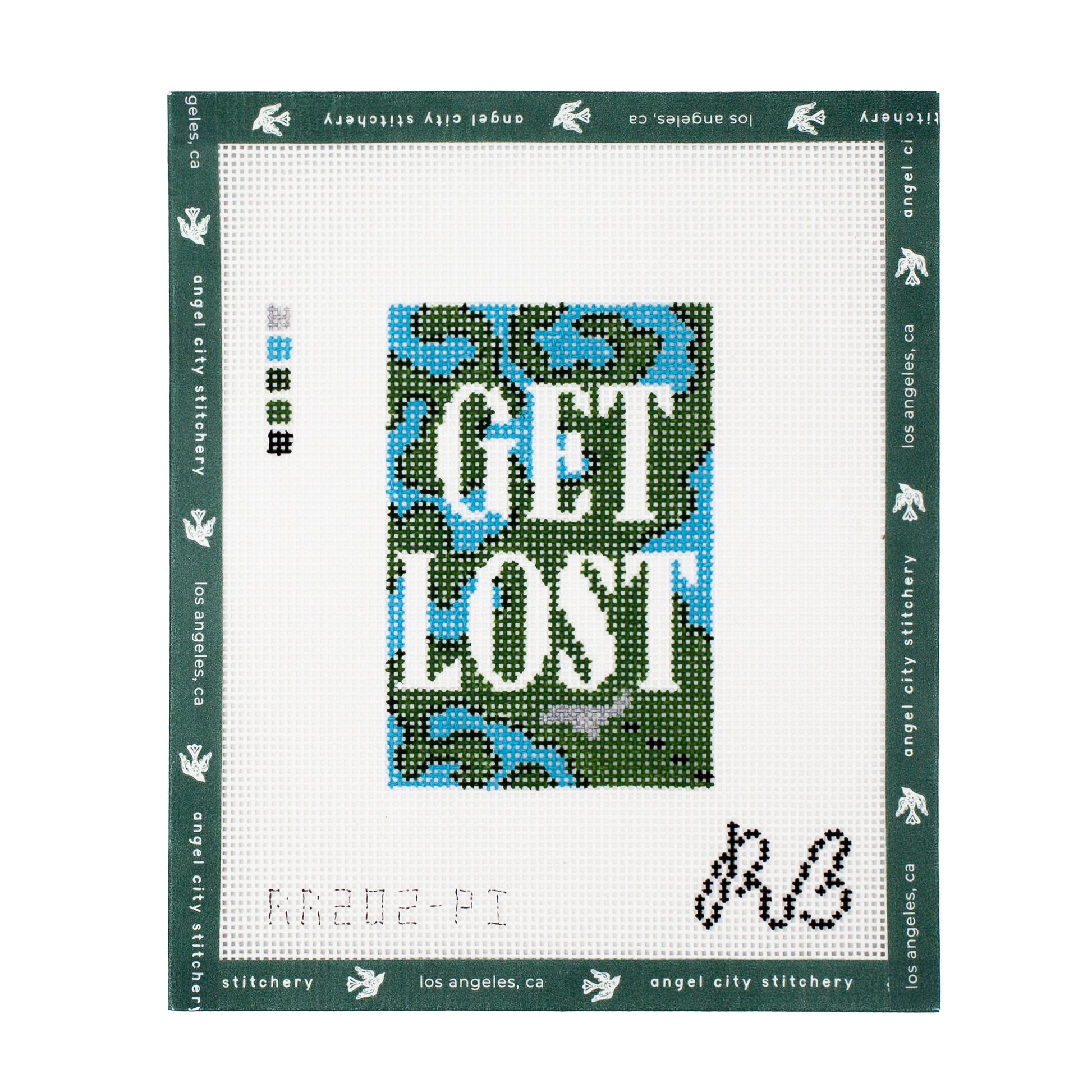A completed needlepoint canvas from Angel City Stitchery, featuring a central square design with a green, blue, and gray camouflage pattern and the words 'GET LOST' in white. 