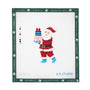 A completed needlepoint canvas featuring a stitched Santa Claus carrying a pink and blue gift box.
