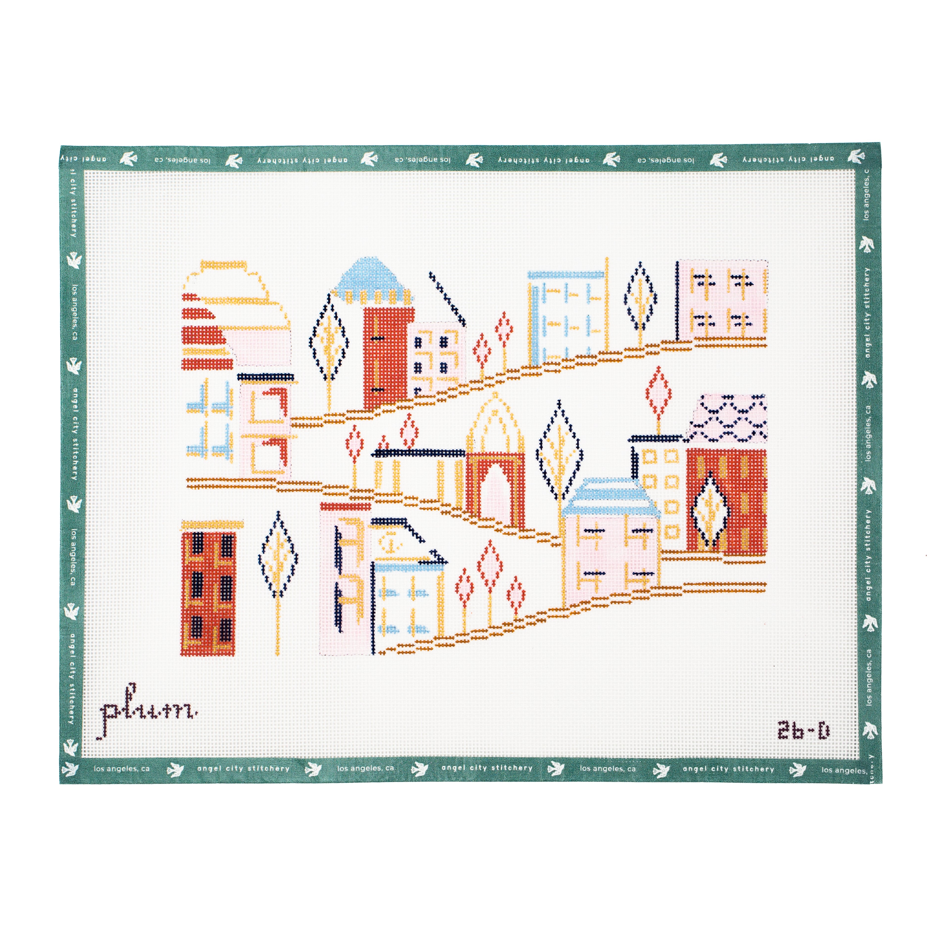 A cross-stitch piece featuring a stylized cityscape with colorful buildings and trees, bordered by a green patterned edge. The word 'plum' is written in script in the lower left, and '2b-6' appears in the lower right.