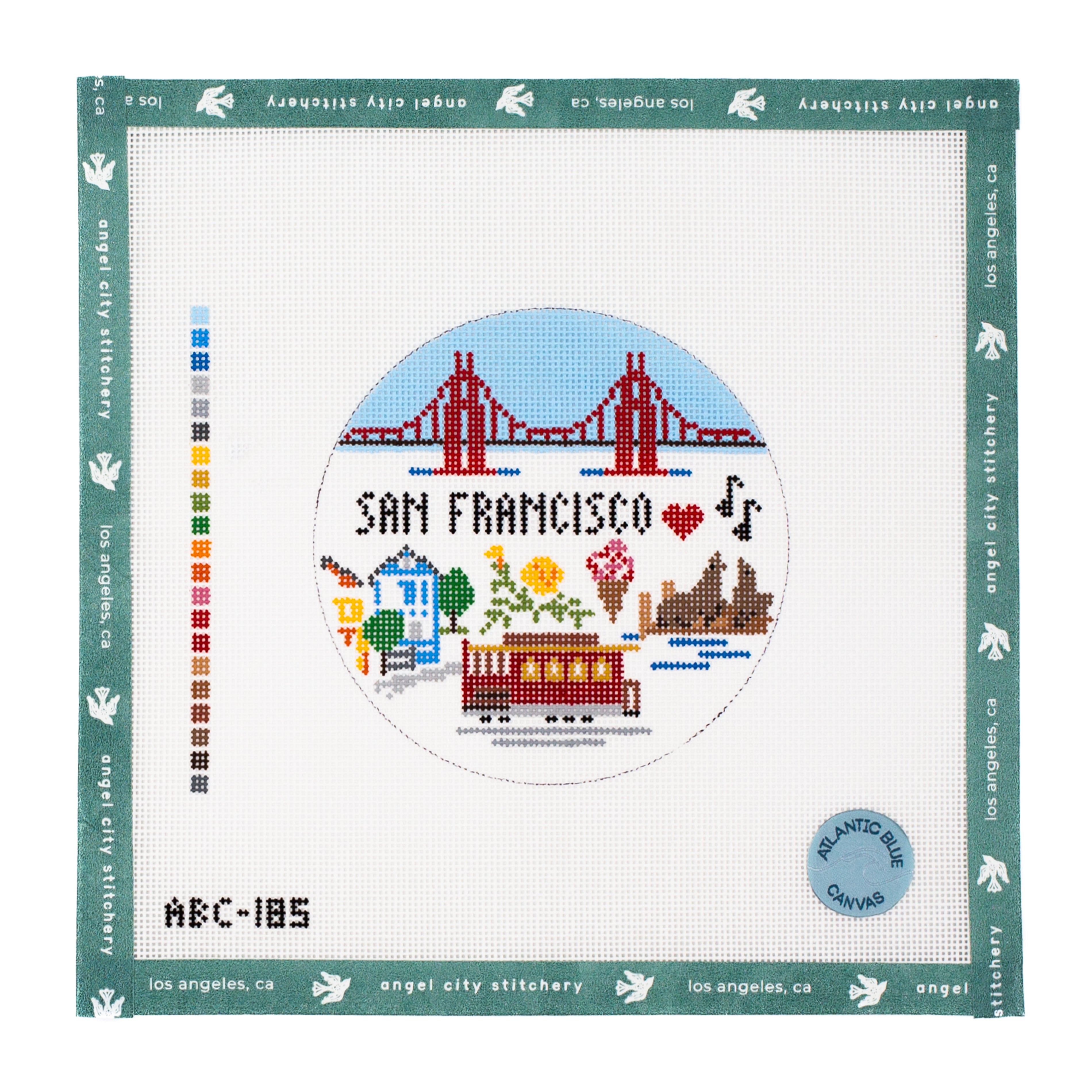 San Francisco scene with the Golden Gate Bridge, cable car, painted ladies, sea lions, and icons round needlepoint canvas by Angel City Stitchery / Atlantic Blue Canvas