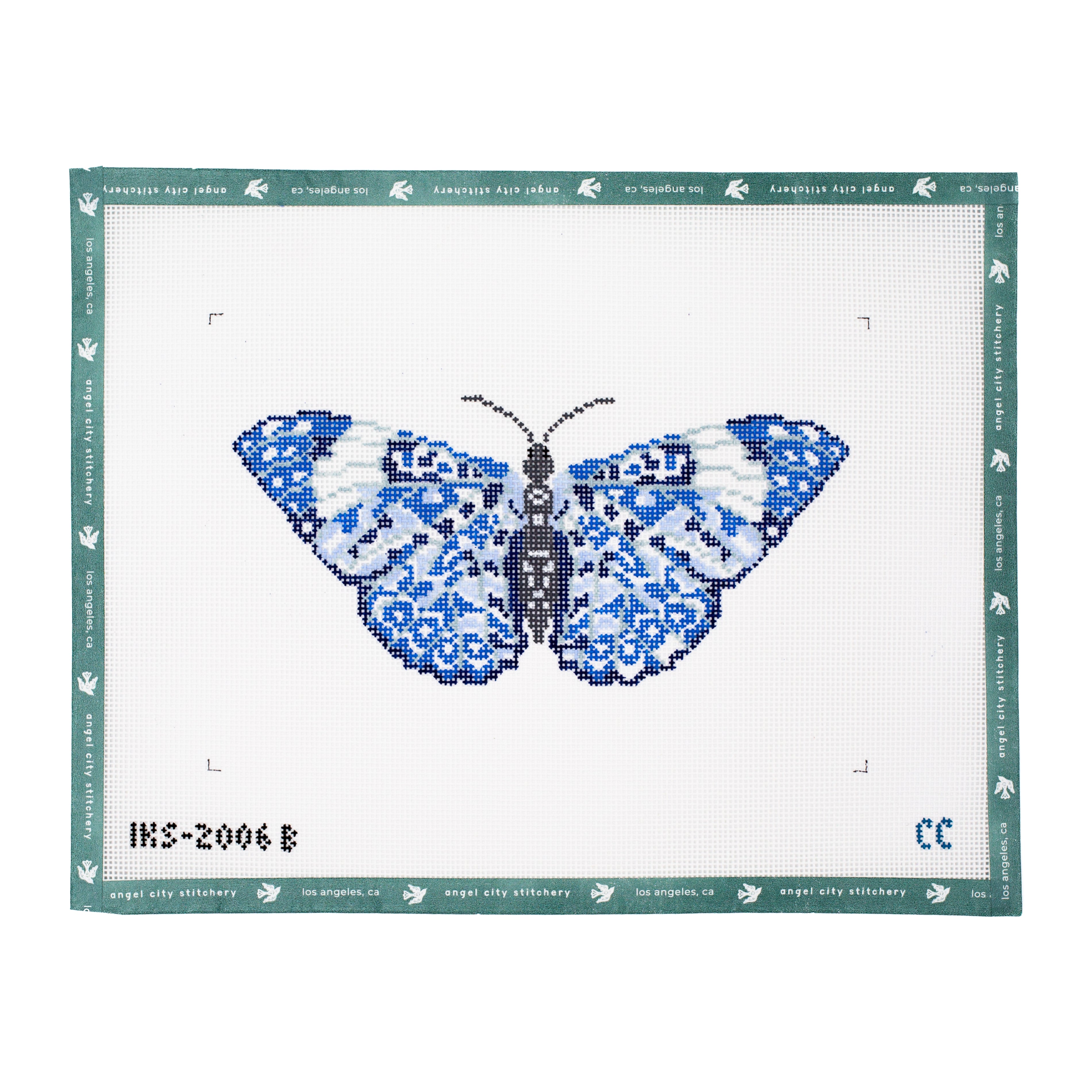 Blue butterfly needlepoint canvas featuring detailed wings in shades of blue, navy, light blue, and white, with a dark patterned body and antennae on a white background