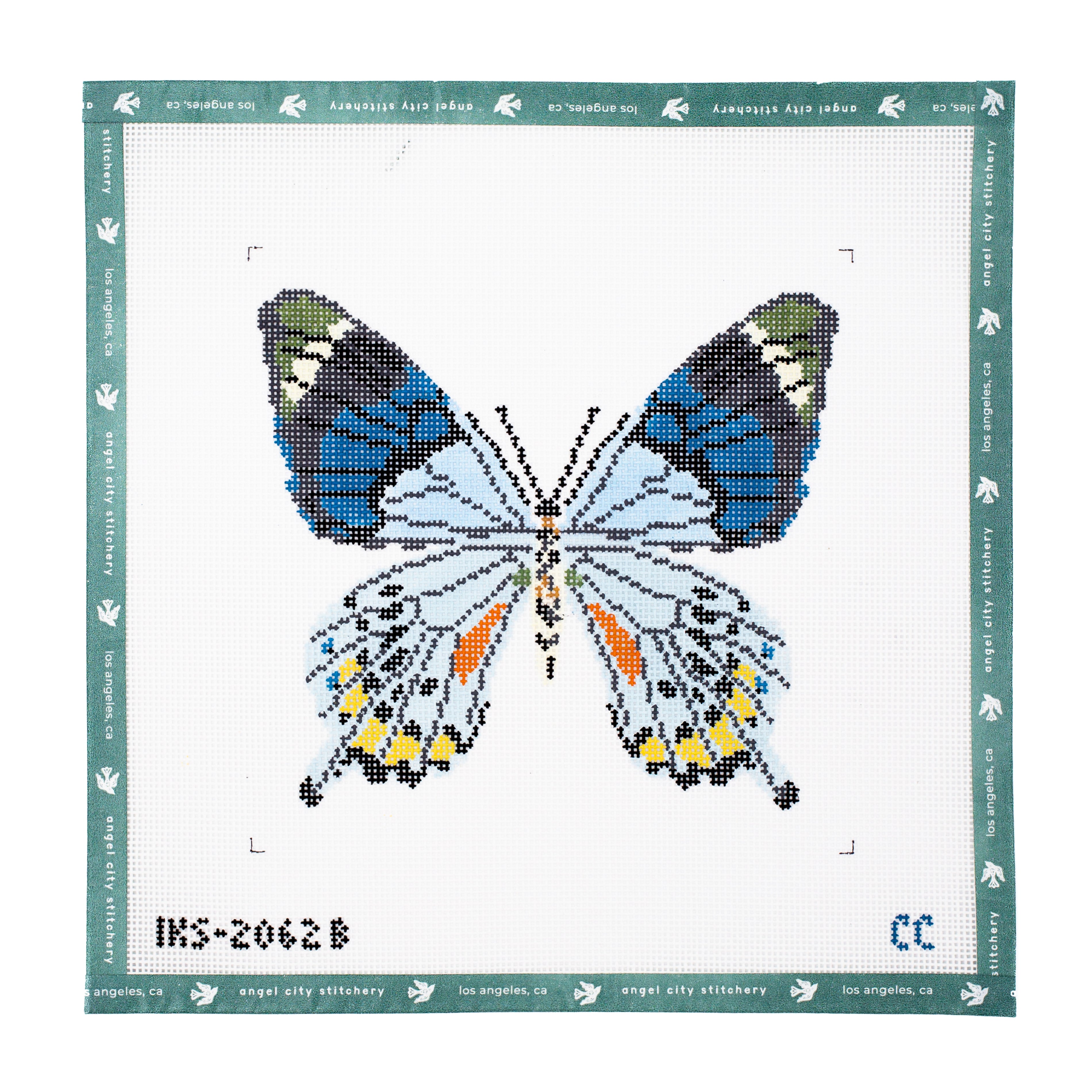 Butterfly needlepoint canvas featuring light blue, dark blue, green, and white upper wings, patterned lower wings with orange and yellow spots, a speckled body, and antennae on a white background
