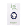 A circular enamel pin by Go Stitch Studio, featuring a navy blue and white illustration of a castle on a ship's wheel, mounted on its original white display card.