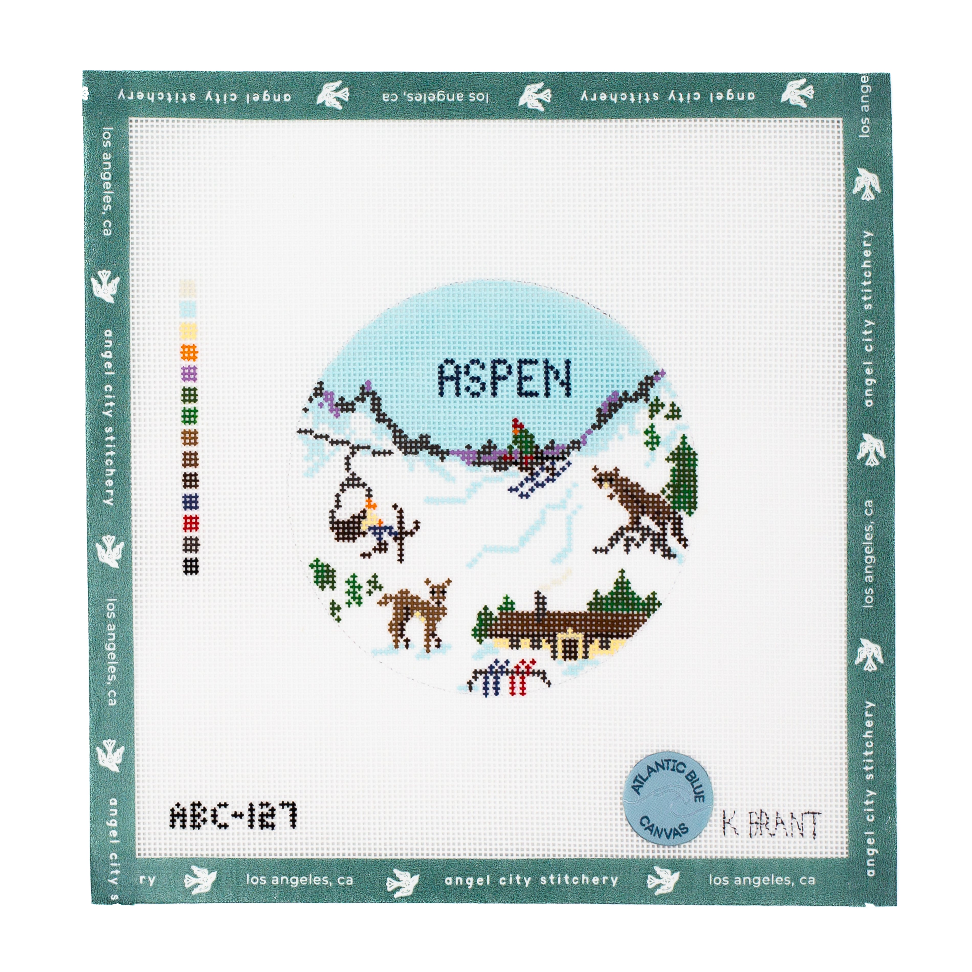 Aspen ski scene with mountains, chairlift, cabin, and wildlife round needlepoint canvas by Angel City Stitchery