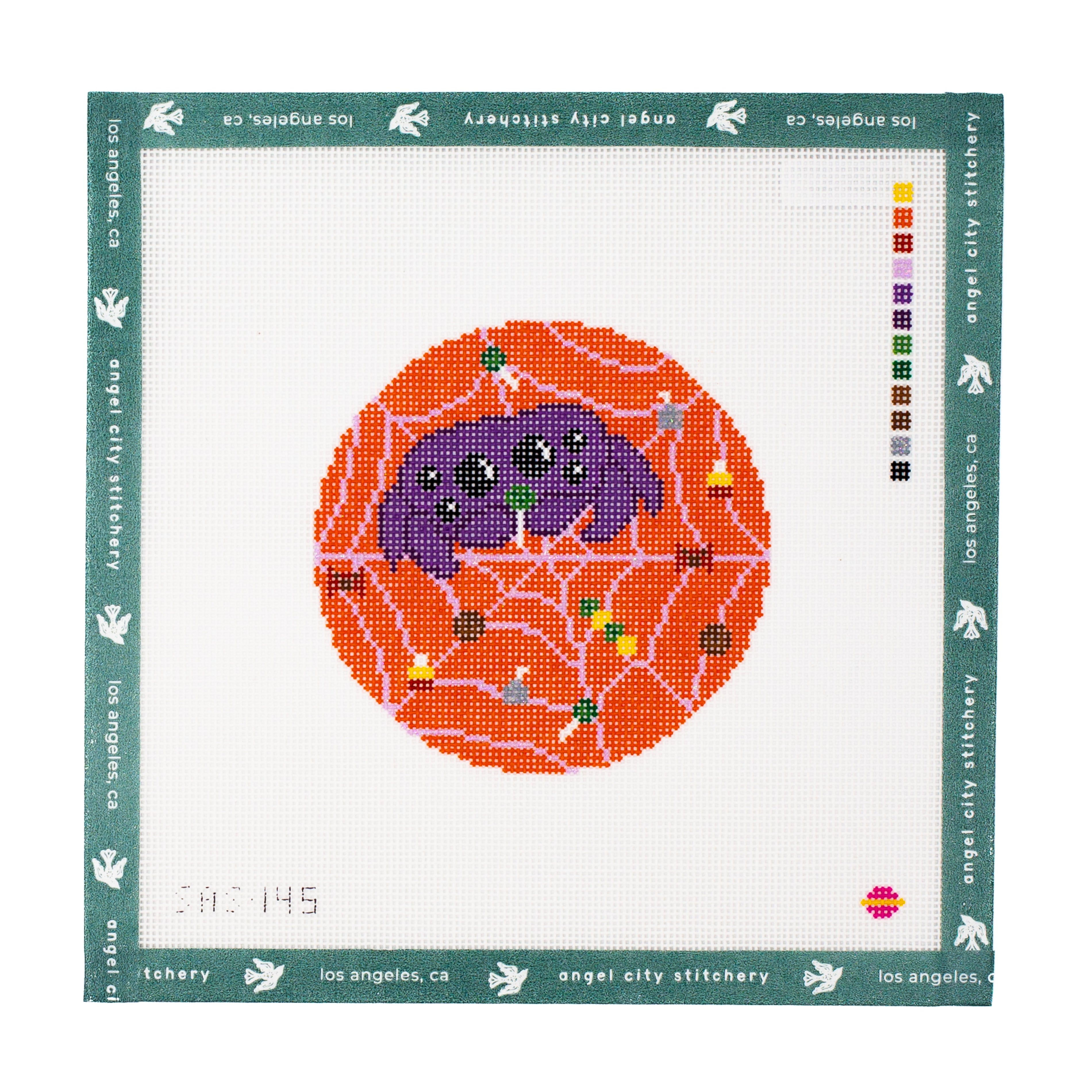 Purple spider on orange web needlepoint canvas by Angel City Stitchery