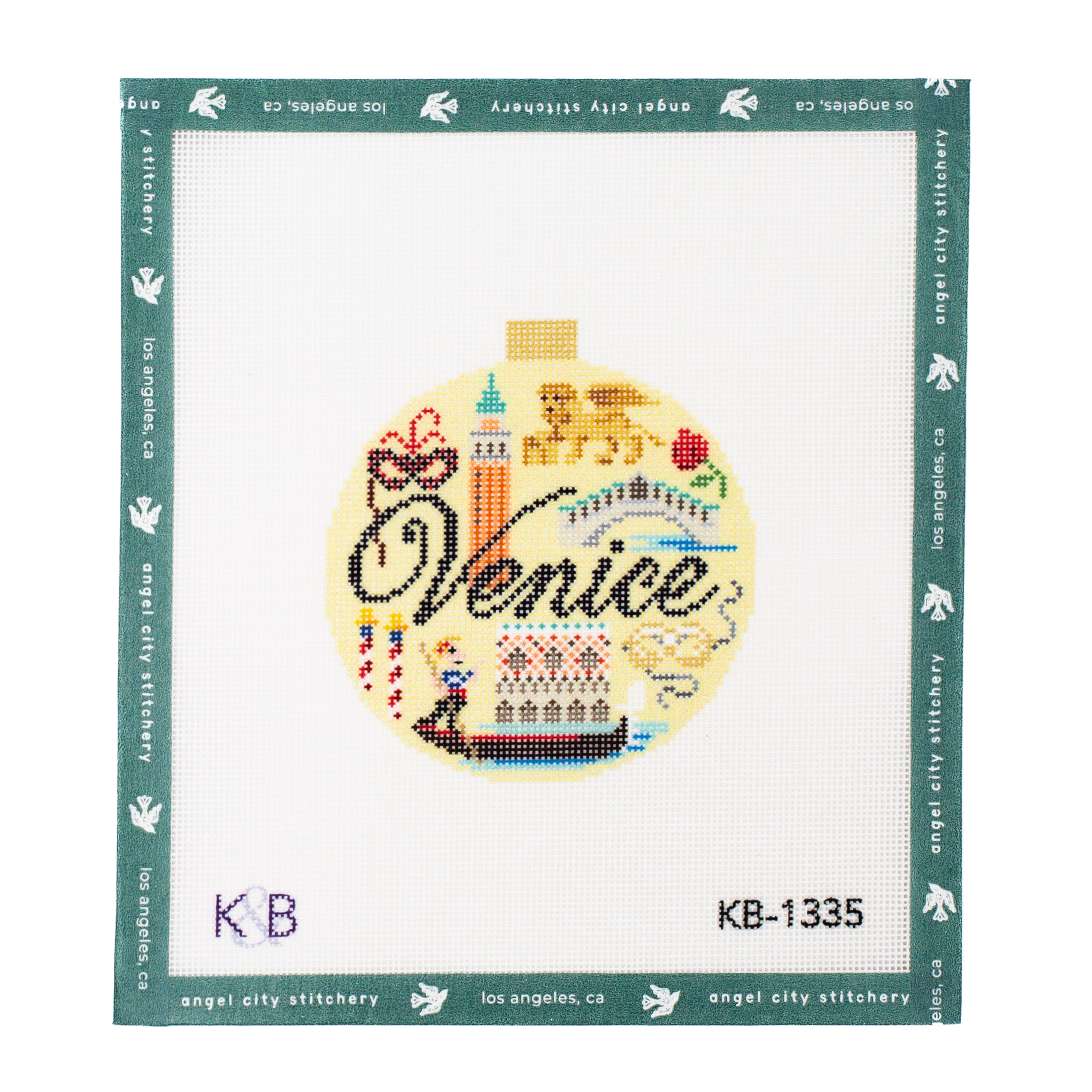 Venice-themed ornament needlepoint canvas featuring icons such as a gondola, a mask, a bridge, a tower, and the word "Venice" in black script on a yellow background with a small hanging tab at the top