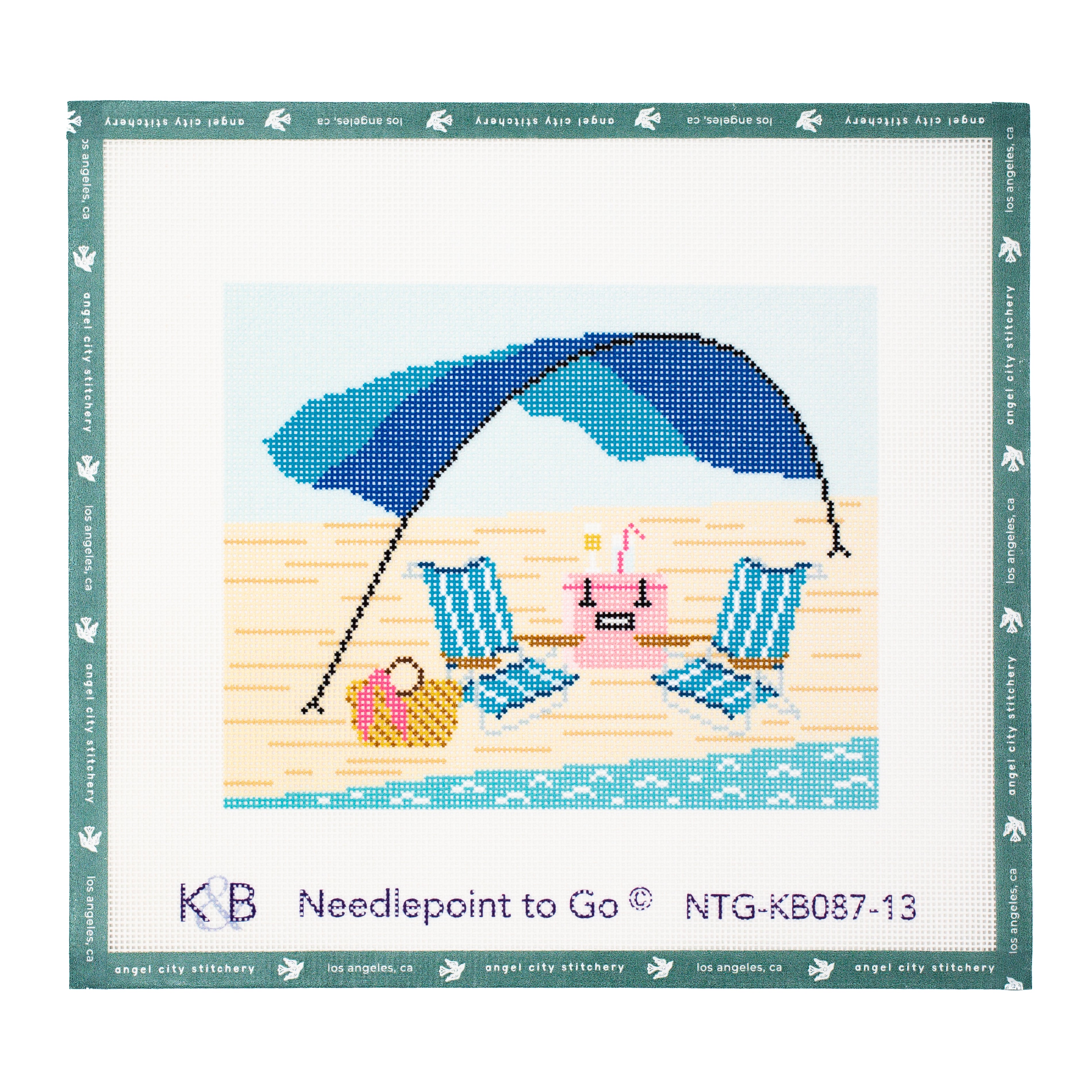 Beach-themed needlepoint canvas featuring two blue and white striped beach chairs, a pink cooler with a drink, a beach bag, and a large blue and turquoise umbrella set on sand by the ocean