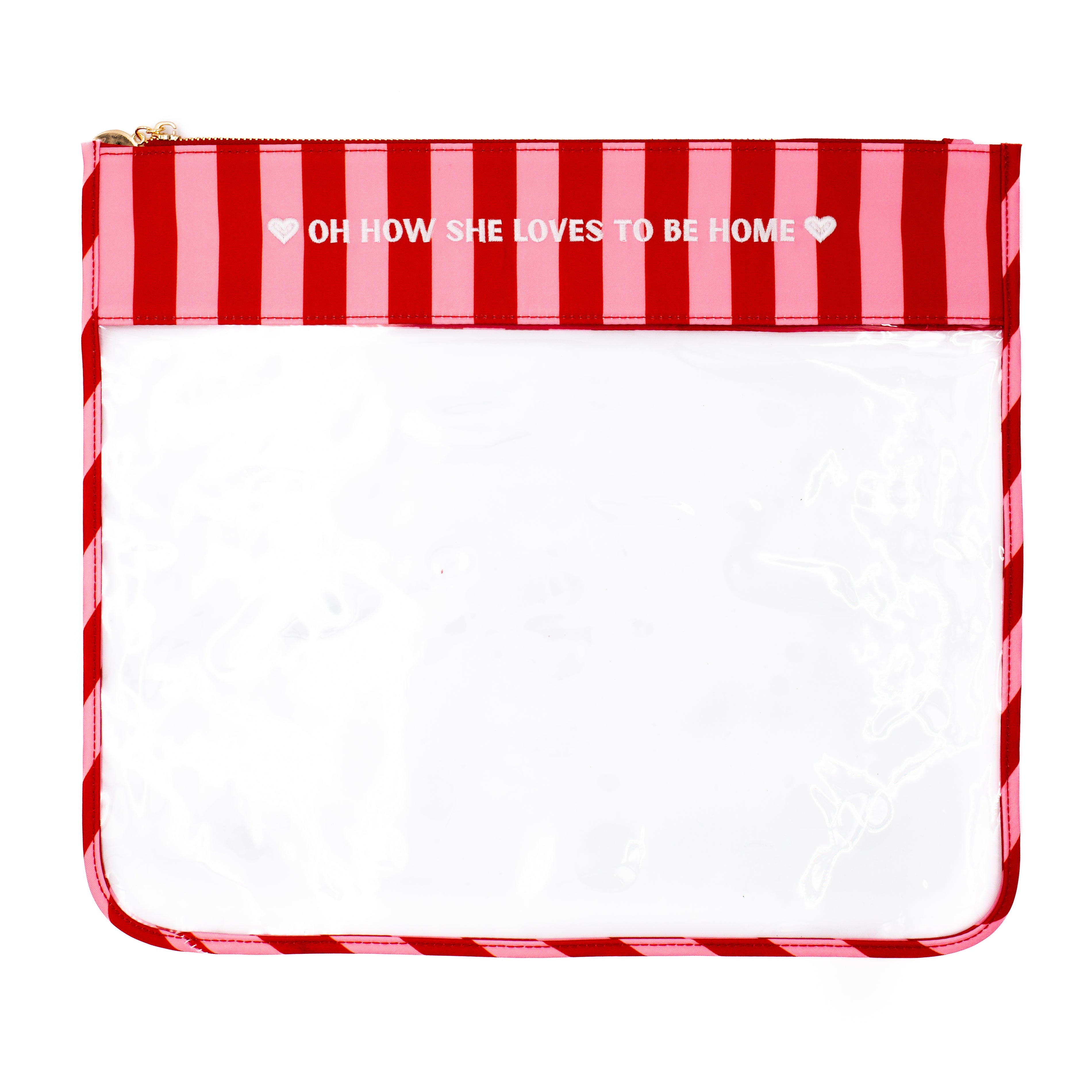 A clear plastic pouch with a red and pink striped top border and zipper trim, featuring the printed phrase 'OH HOW SHE LOVES TO BE HOME' on a white background.