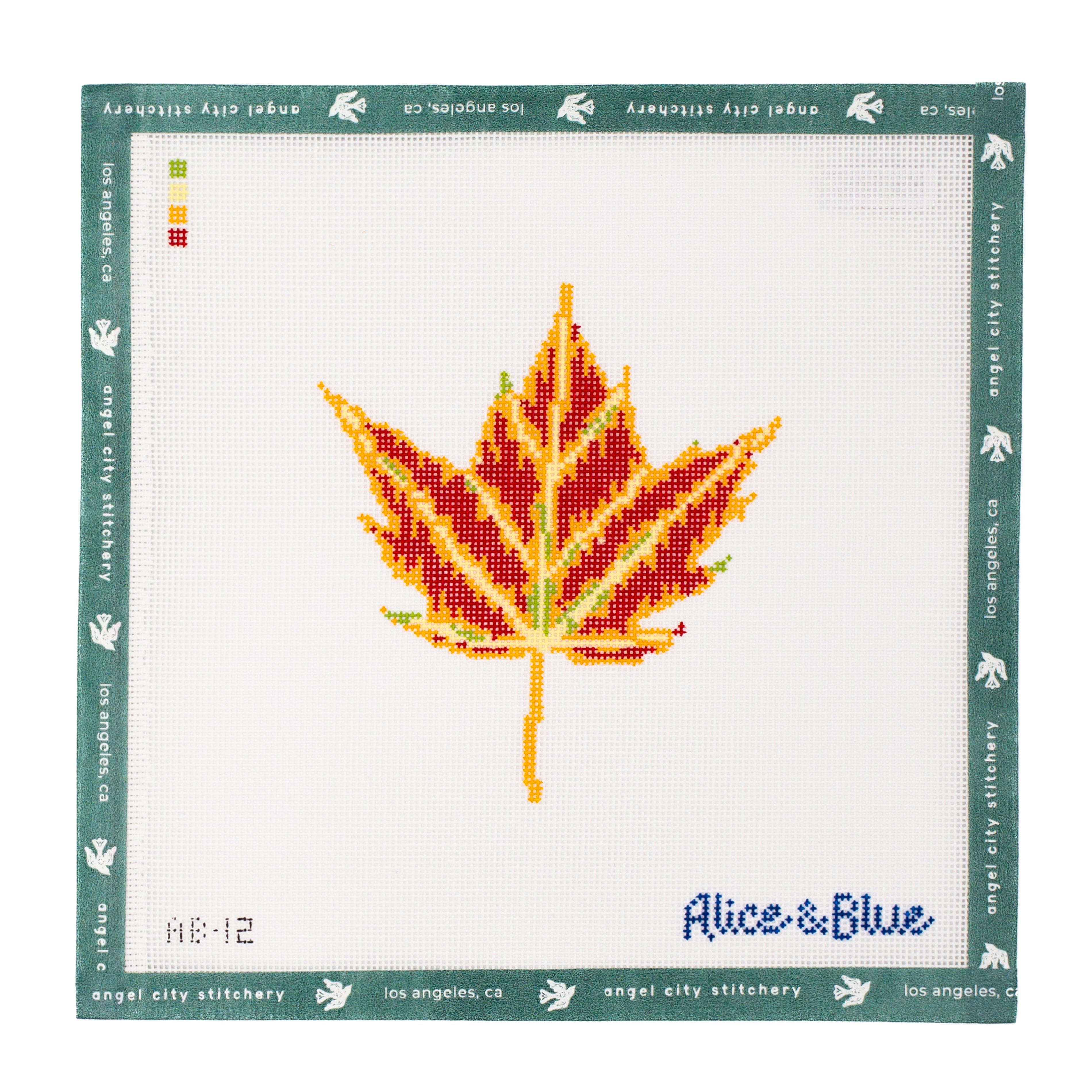Maple leaf needlepoint canvas featuring autumn colors of red, orange, yellow, and green veins on a white background, with a signature in the bottom right corner