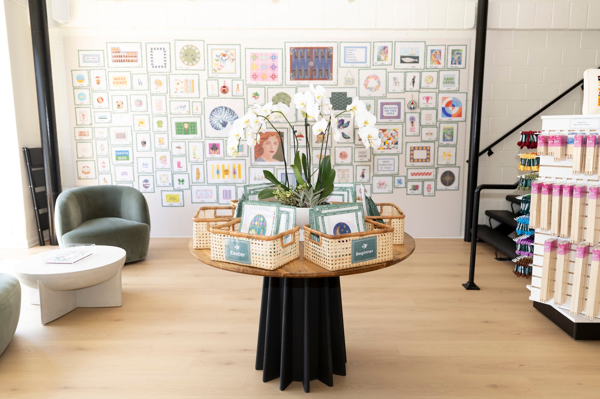 Display of photo frames and decorative items in a store setting with a wall of framed pictures.