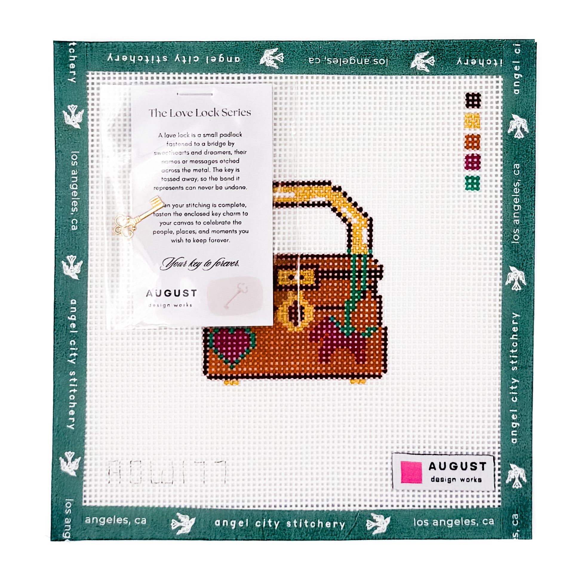 A completed cross-stitch design from the Love Lock Series by August Design Works, featuring a brown and gold treasure chest with colorful floral details, displayed on a white stitched canvas with a dark green branded border.