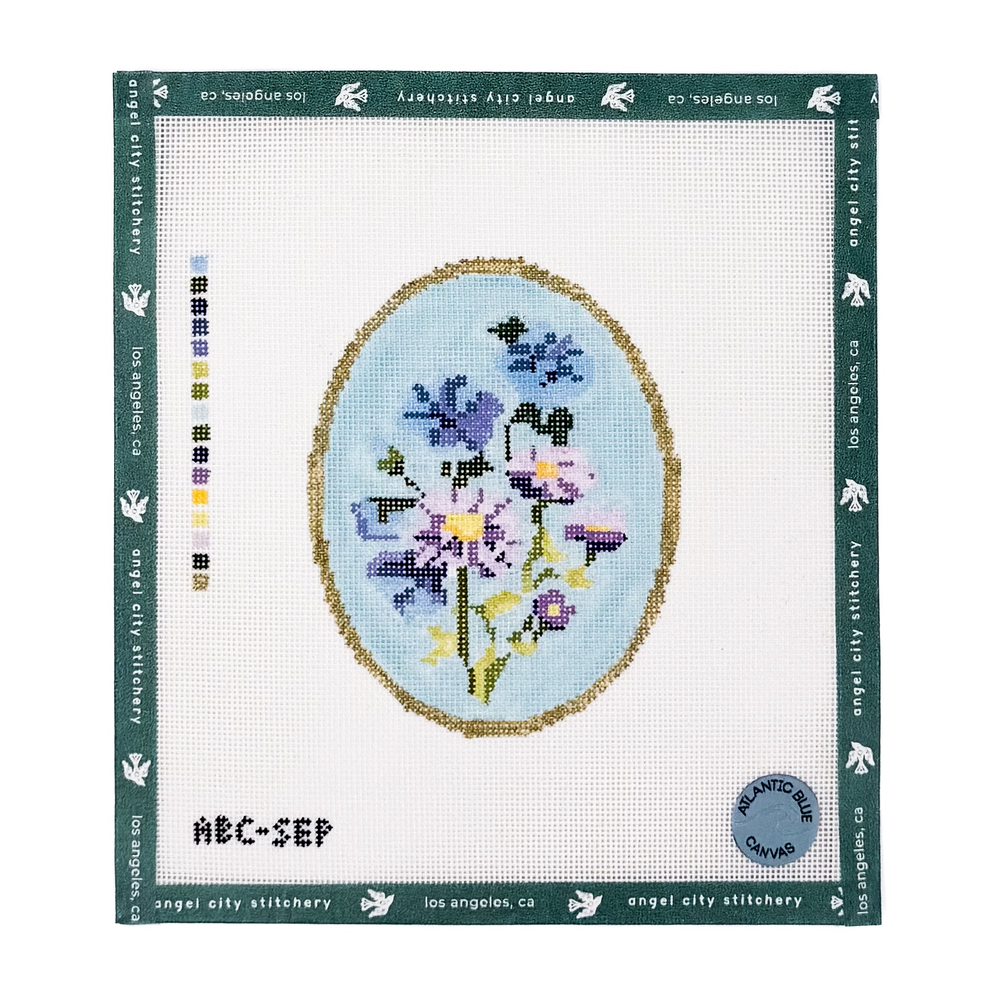Blue and purple floral bouquet inside an oval gold frame needlepoint canvas
