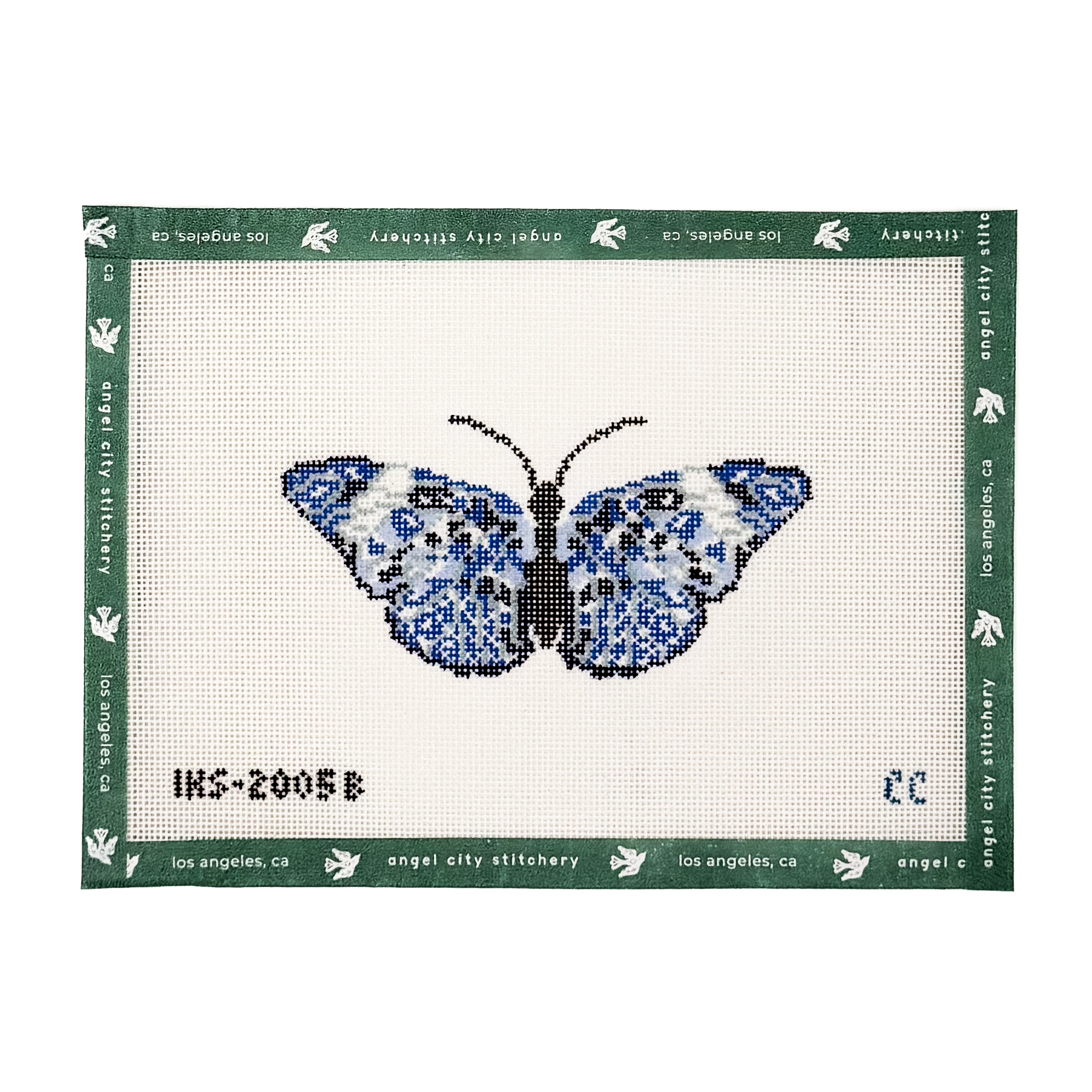Blue and white butterfly needlepoint canvas featuring patterned wings in shades of blue, black, and light grey, with a solid black body and antennae on a white background