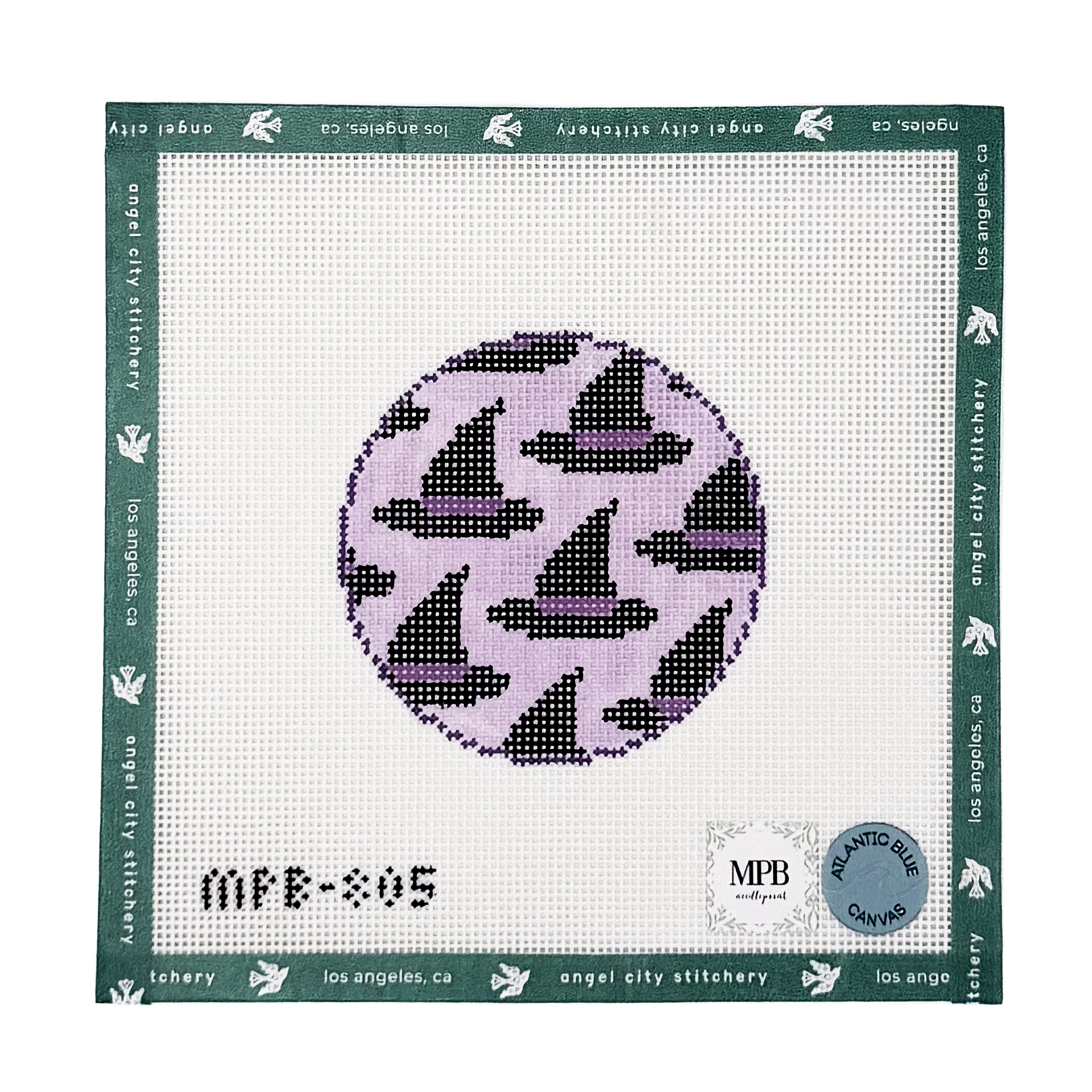 Circular needlepoint canvas featuring a pattern of black witch hats with purple bands on a light purple background